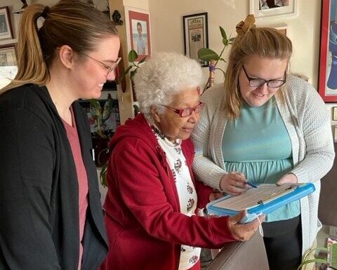 Agebetter employees helping older woman participate in its Safe at Home program
